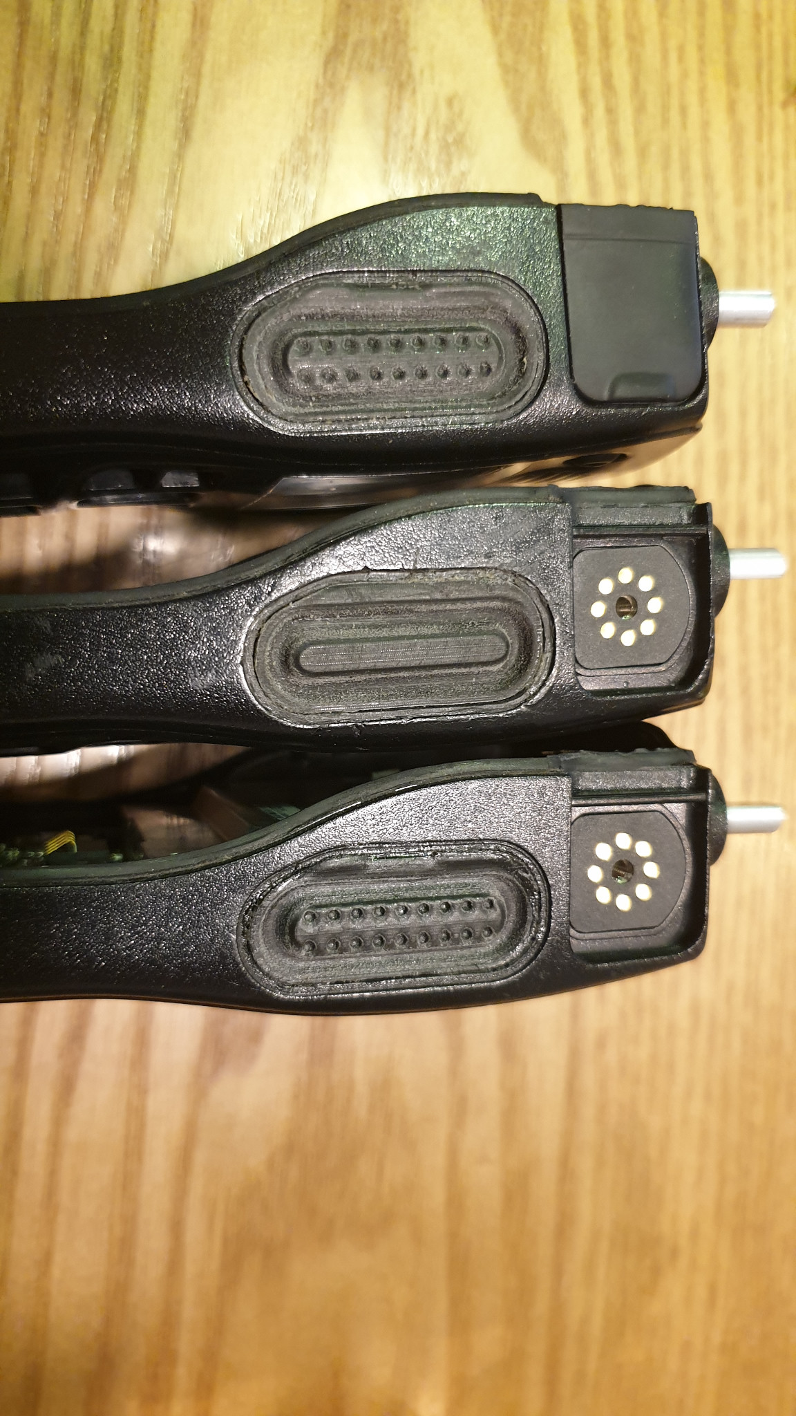 Three two-way radio devices fitted with black replacement buttons