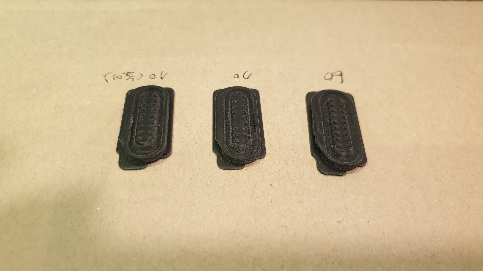 Three black radio replacement-button samples arranged for shape comparison